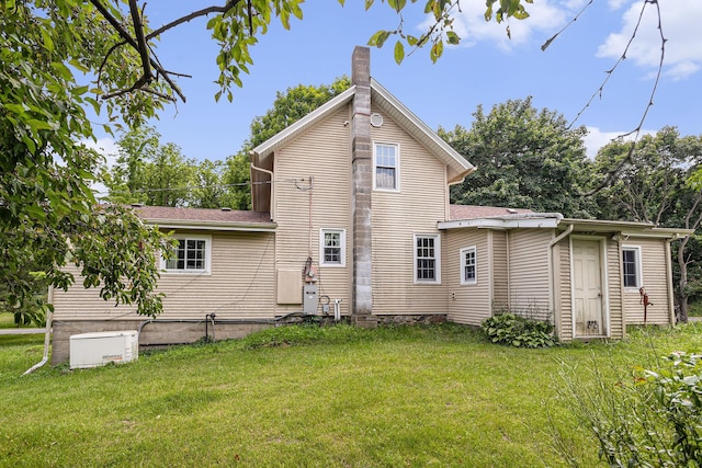 20821 J Dr N, Marshall, MI 49068 - rear view of house featuring a yard, a chimney, and a shingled roof