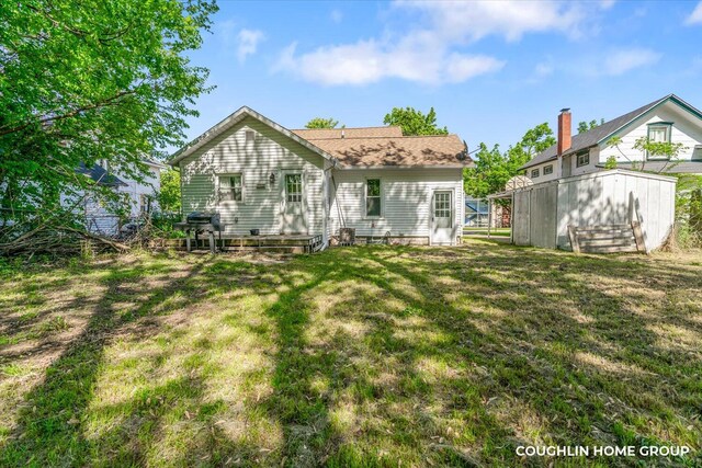 610 S Park St, Hastings, MI 49058 - rear view of property featuring a lawn