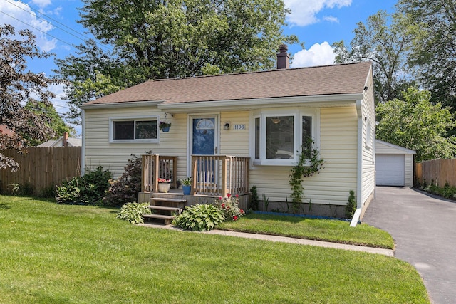 1198 Hawthorne Ave, Ypsilanti, MI 48198 - bungalow-style house with a garage, an outbuilding, a chimney, and a shingled roof