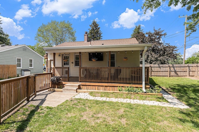 1198 Hawthorne Ave, Ypsilanti, MI 48198 - back of property with a chimney, a shingled roof, and a porch