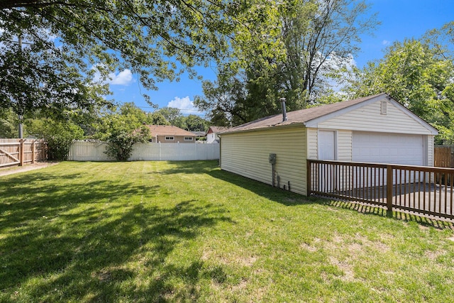 1198 Hawthorne Ave, Ypsilanti, MI 48198 - fenced backyard featuring a garage and an outbuilding