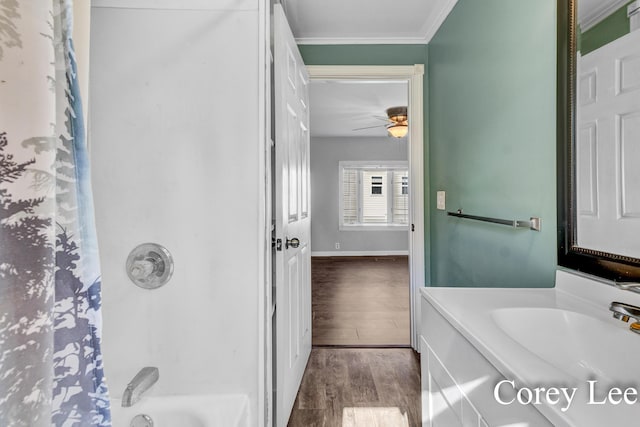 413 W Riverside Dr, Ionia, MI 48846 - full bathroom featuring vanity, ornamental molding, wood finished floors, a ceiling fan, and shower / bath combo with shower curtain