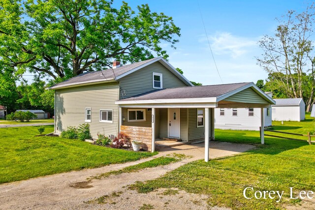 413 W Riverside Dr, Ionia, MI 48846 - view of front of home with a front yard, covered porch, and roof with shingles