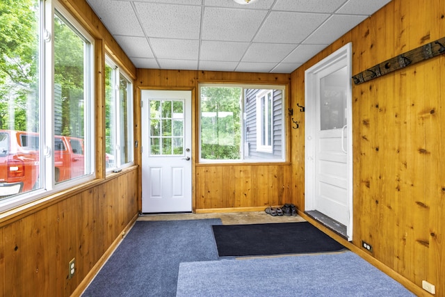 595 133rd Ave, Wayland, MI 49348 - unfurnished sunroom featuring wooden walls, carpet flooring, plenty of natural light, and a drop ceiling