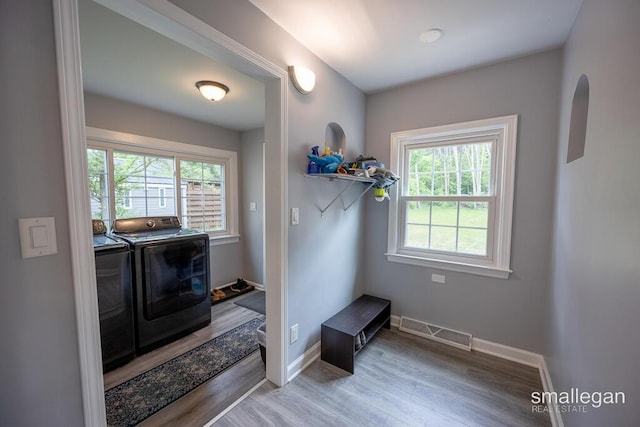 5161 Grand River Dr NE, Grand Rapids, MI 49525 - washroom featuring washing machine and clothes dryer and wood finished floors