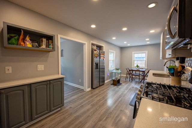 5161 Grand River Dr NE, Grand Rapids, MI 49525 - kitchen with appliances with stainless steel finishes, recessed lighting, light countertops, and wood finished floors