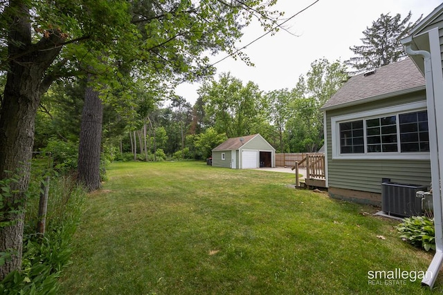 5161 Grand River Dr NE, Grand Rapids, MI 49525 - view of grassy yard with a detached garage and an outdoor structure