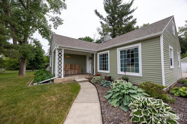 5161 Grand River Dr NE, Grand Rapids, MI 49525 - single story home featuring a front lawn, a chimney, roof with shingles, and a porch