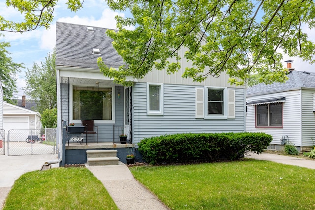 639 Cleveland, Lincoln Park, MI 48146 - view of front of property with a porch, board and batten siding, a gate, roof with shingles, and a garage