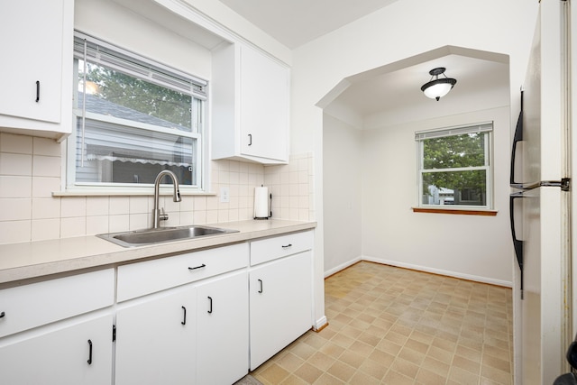 639 Cleveland, Lincoln Park, MI 48146 - kitchen featuring freestanding refrigerator, tasteful backsplash, light countertops, and white cabinets