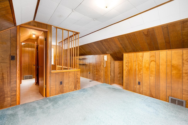 639 Cleveland, Lincoln Park, MI 48146 - additional living space with vaulted ceiling, wood walls, and carpet flooring