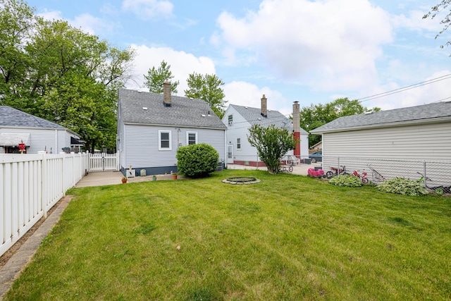 639 Cleveland, Lincoln Park, MI 48146 - rear view of house featuring a fenced backyard and an outdoor fire pit