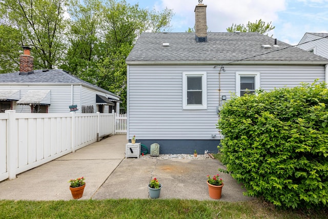 639 Cleveland, Lincoln Park, MI 48146 - back of property with a patio area, a chimney, and roof with shingles