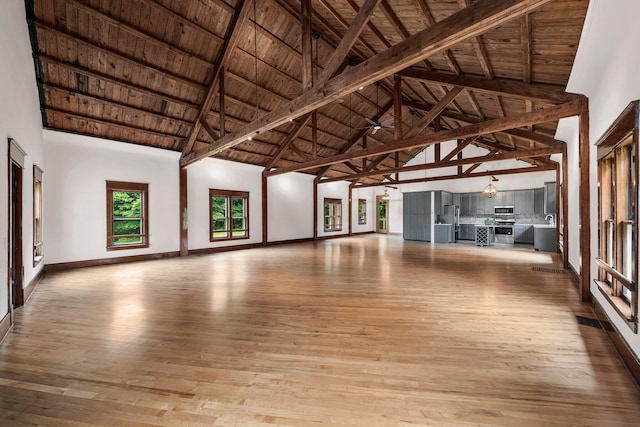 13060 Broadway Rd, Three Rivers, MI 49093 - unfurnished living room featuring high vaulted ceiling, a wood ceiling with exposed beams, and wood-type flooring