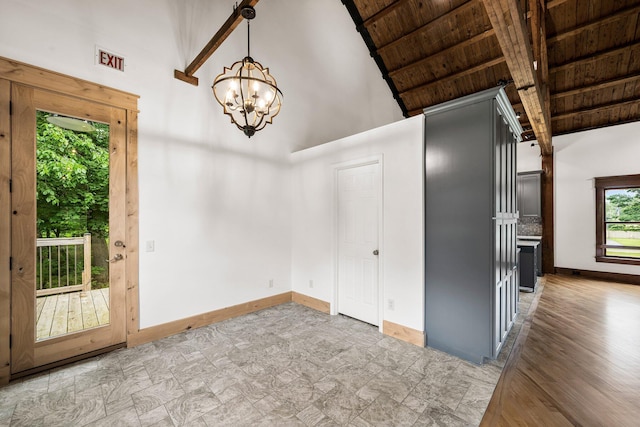 13060 Broadway Rd, Three Rivers, MI 49093 - spare room featuring a wooden ceiling with exposed beams, a chandelier, high vaulted ceiling, and light stone finish flooring