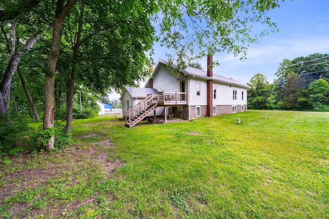 13060 Broadway Rd, Three Rivers, MI 49093 - back of house with stairway, a chimney, a wooden deck, and a yard