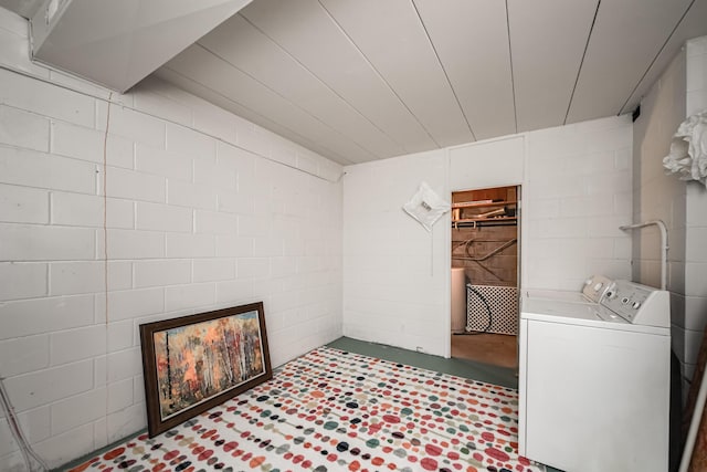 4075 N Delhi Rd, Ann Arbor, MI 48103 - laundry area with concrete block wall, tile patterned floors, and washer and clothes dryer