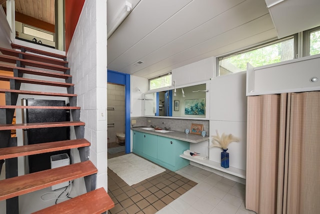 4075 N Delhi Rd, Ann Arbor, MI 48103 - bathroom featuring vanity, tile patterned floors, and backsplash
