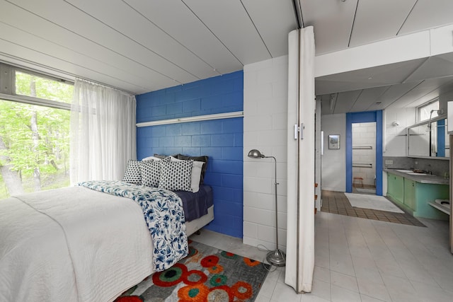 4075 N Delhi Rd, Ann Arbor, MI 48103 - bedroom featuring concrete block wall and ensuite bath