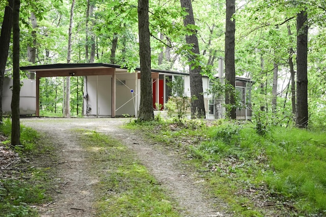 4075 N Delhi Rd, Ann Arbor, MI 48103 - mid-century modern home with dirt driveway and a carport