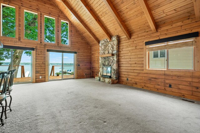 9715 Woodlawn Dr, Portage, MI 49002 - unfurnished living room with a wooden ceiling with exposed beams, wooden walls, a water view, high vaulted ceiling, and a stone fireplace