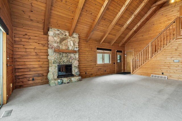 9715 Woodlawn Dr, Portage, MI 49002 - unfurnished living room with wooden walls, stairs, a wood ceiling with exposed beams, a fireplace, and carpet