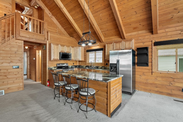 9715 Woodlawn Dr, Portage, MI 49002 - kitchen featuring black microwave, stainless steel refrigerator with ice dispenser, wooden walls, a breakfast bar, and light colored carpet