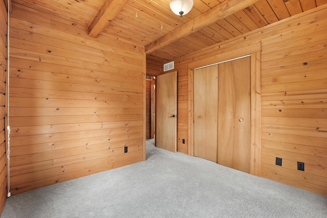9715 Woodlawn Dr, Portage, MI 49002 - unfurnished bedroom featuring a wood ceiling with exposed beams, carpet floors, wood walls, and a closet