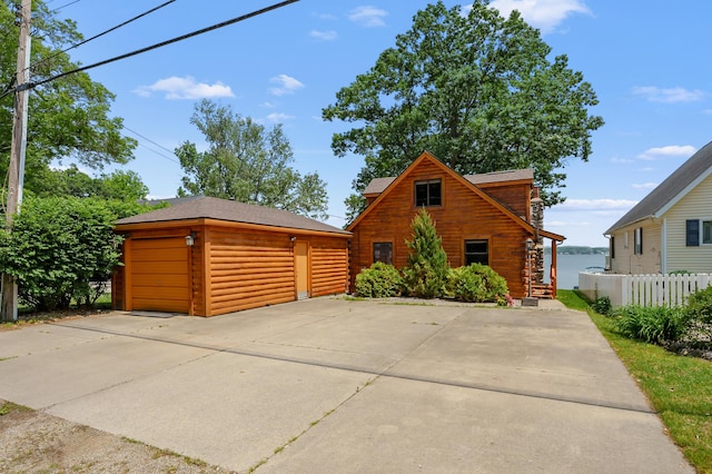 9715 Woodlawn Dr, Portage, MI 49002 - log-style house featuring an outbuilding and log siding