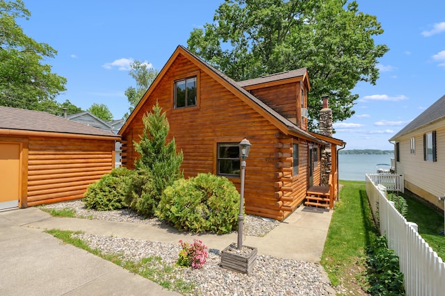 9715 Woodlawn Dr, Portage, MI 49002 - view of side of home featuring log exterior, a water view, and a shingled roof