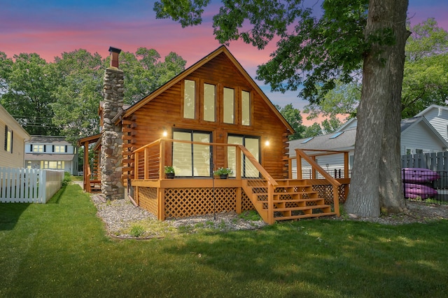 9715 Woodlawn Dr, Portage, MI 49002 - back of property at dusk with log exterior, a chimney, a wooden deck, and stairs
