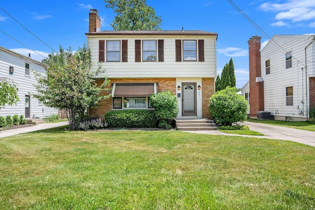 1932 Concord Ave SE, Grand Rapids, MI 49506 - view of front of home featuring a front yard, brick siding, and a chimney