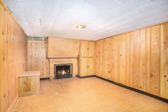 1932 Concord Ave SE, Grand Rapids, MI 49506 - unfurnished living room with tile patterned floors, wooden walls, and a brick fireplace