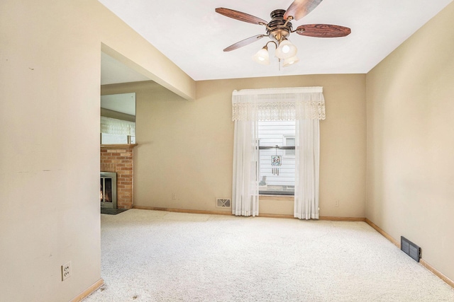 1932 Concord Ave SE, Grand Rapids, MI 49506 - carpeted spare room with healthy amount of natural light, a ceiling fan, and a fireplace