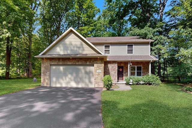 5026 Weatherford Dr, Coloma, MI 49038 - view of front of house with asphalt driveway, stone siding, a garage, and a front yard