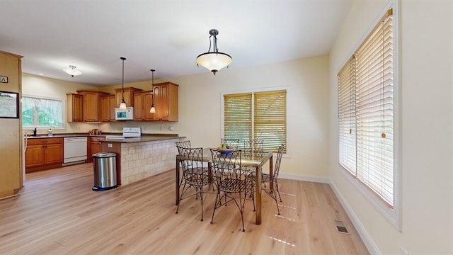 5026 Weatherford Dr, Coloma, MI 49038 - dining area with light wood finished floors and baseboards