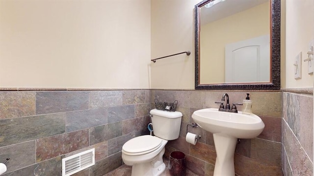 5026 Weatherford Dr, Coloma, MI 49038 - half bathroom featuring a wainscoted wall and tile walls