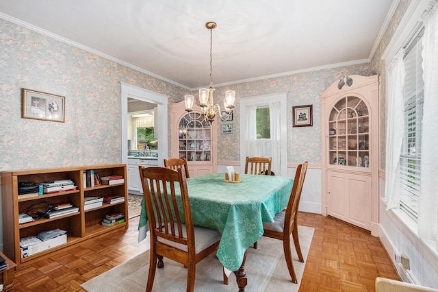 311 Moccasin St, Buchanan, MI 49107 - dining space with wallpapered walls, a chandelier, a wainscoted wall, healthy amount of natural light, and crown molding