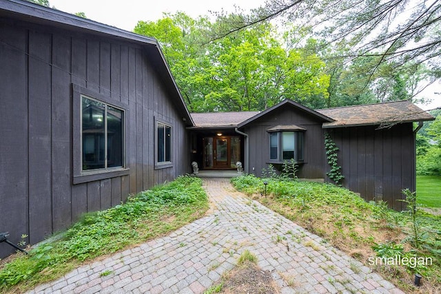 550 Greentree Ln NE, Ada, MI 49301 - entrance to property featuring roof with shingles