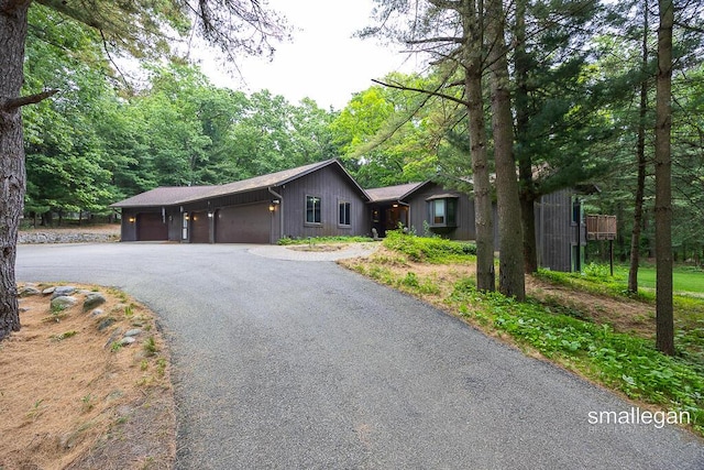 550 Greentree Ln NE, Ada, MI 49301 - ranch-style house with driveway and an attached garage