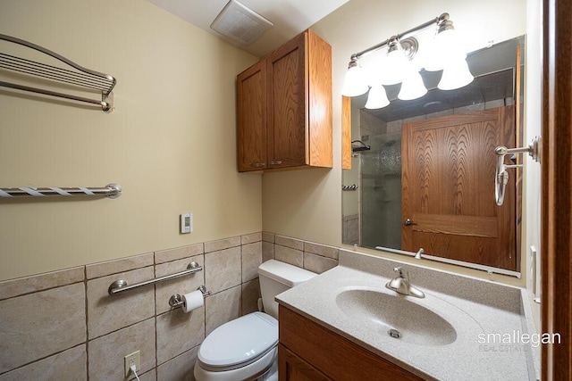 550 Greentree Ln NE, Ada, MI 49301 - bathroom featuring tiled shower, vanity, tile walls, and a wainscoted wall