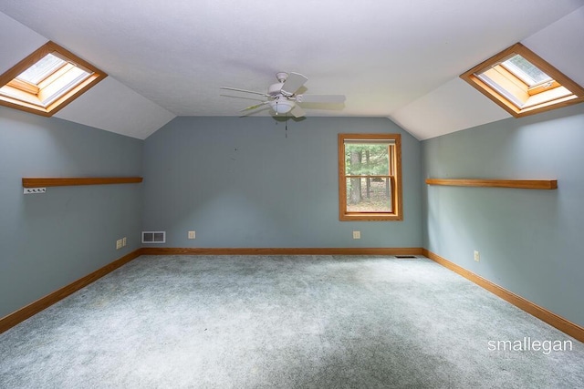 550 Greentree Ln NE, Ada, MI 49301 - additional living space featuring a skylight, lofted ceiling, carpet floors, and a ceiling fan