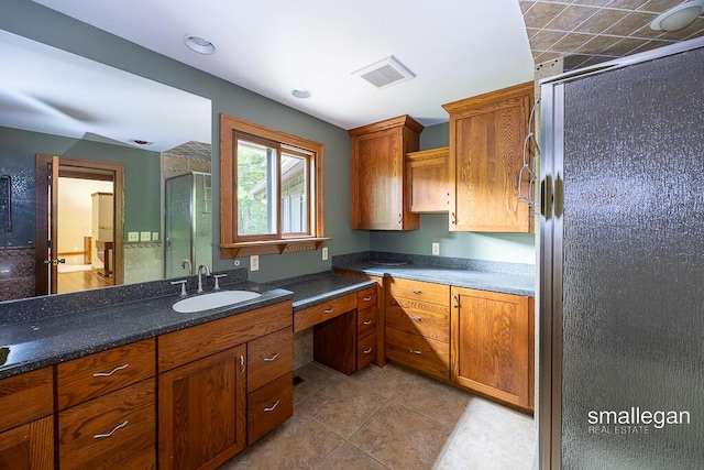 550 Greentree Ln NE, Ada, MI 49301 - kitchen featuring fridge, brown cabinets, and light tile patterned floors
