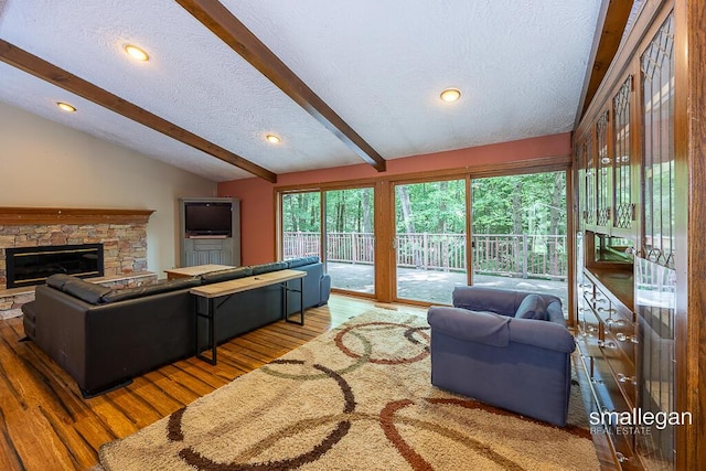 550 Greentree Ln NE, Ada, MI 49301 - living room with a textured ceiling, wood finished floors, a fireplace, and recessed lighting