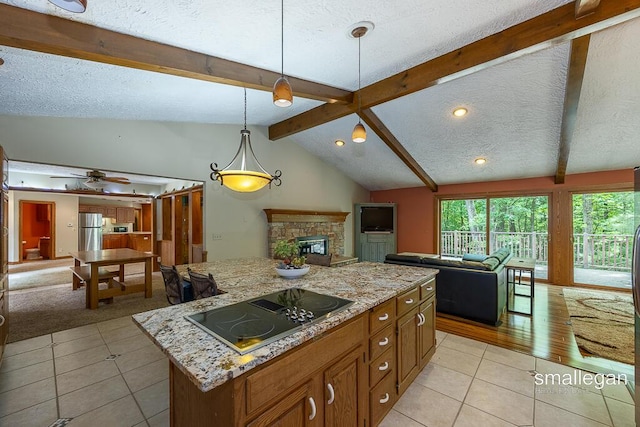 550 Greentree Ln NE, Ada, MI 49301 - kitchen featuring open floor plan, black electric stovetop, light tile patterned flooring, brown cabinetry, and a textured ceiling