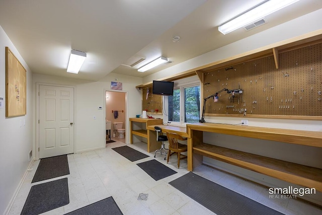550 Greentree Ln NE, Ada, MI 49301 - below grade area featuring a workshop area and light floors