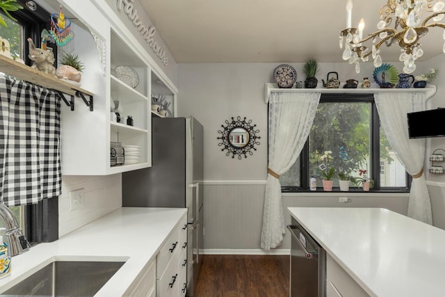 3155 24th Ave, Hudsonville, MI 49426 - kitchen with appliances with stainless steel finishes, white cabinets, a chandelier, dark wood-style floors, and light countertops