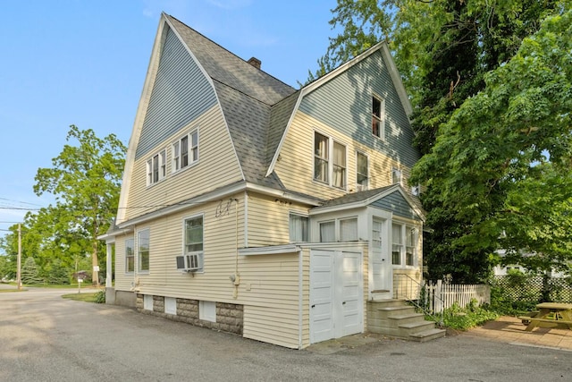 3155 24th Ave, Hudsonville, MI 49426 - view of property exterior with a gambrel roof, roof with shingles, cooling unit, and a chimney