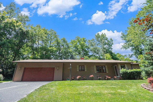 4104 Rurik Dr, Howell, MI 48843 - view of front of home featuring an attached garage, a front lawn, driveway, and a chimney