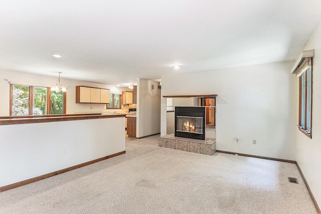 4104 Rurik Dr, Howell, MI 48843 - unfurnished living room with a chandelier, a tile fireplace, light carpet, and recessed lighting